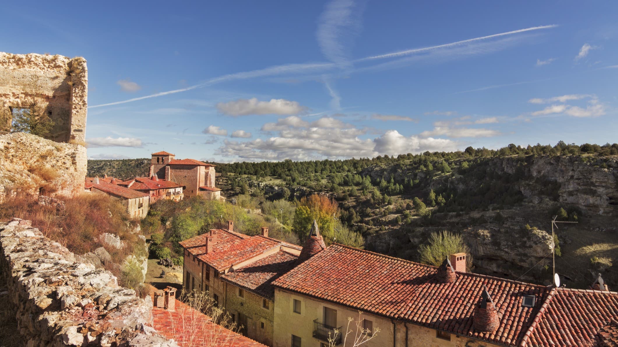 a town with traditional houses and blue sky above.