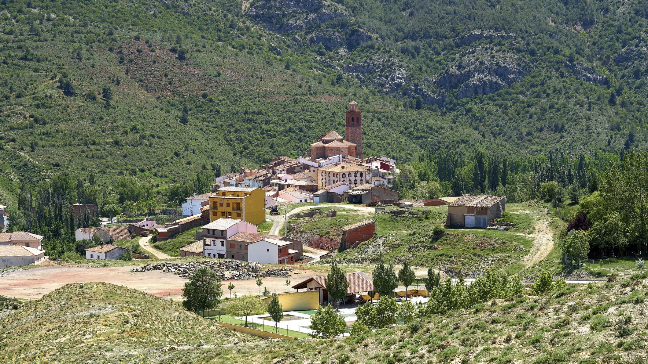 some buildings against a backdrop of greenery.