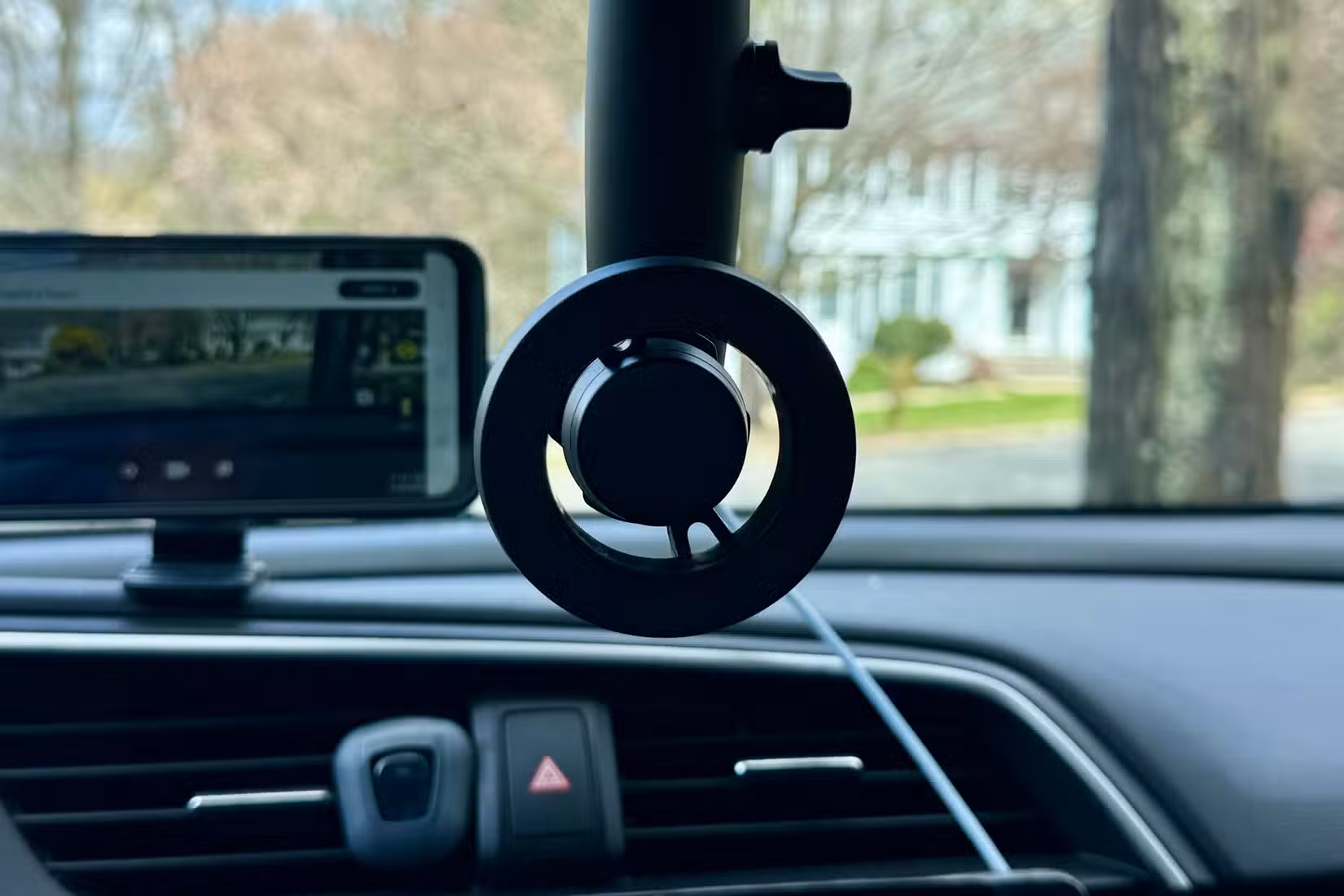 Magnetic phone holder from the rear-view mirror in a car.