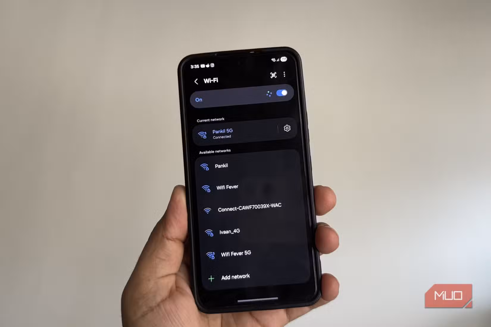 Phone in hand showing nearby Wi-Fi networks