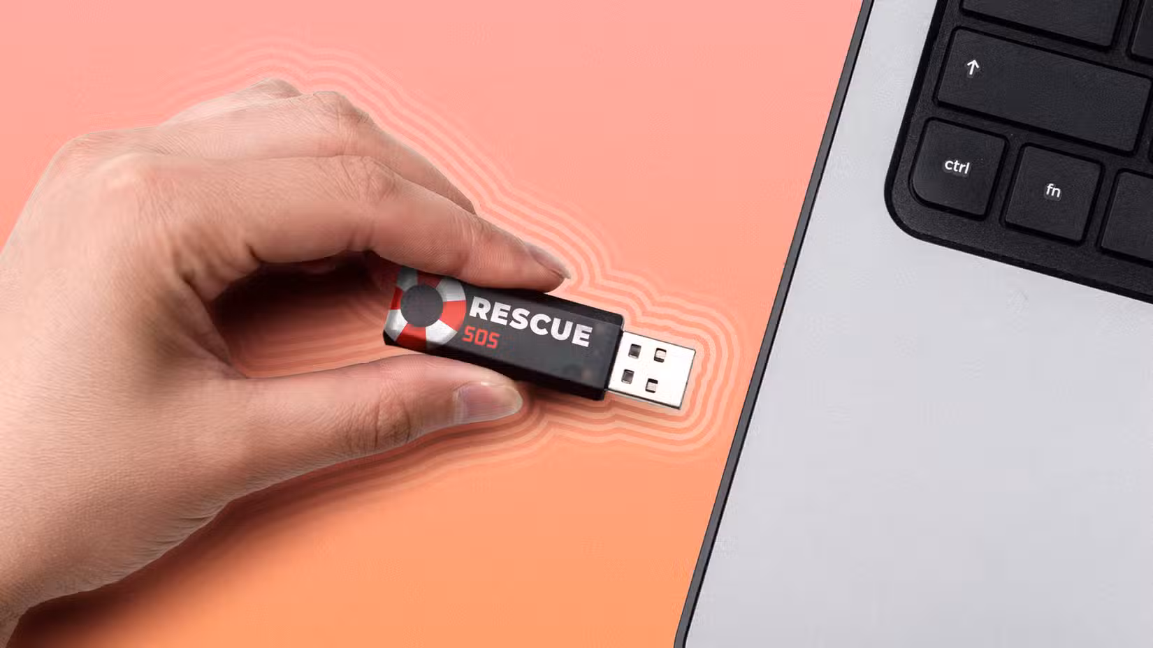 Hand inserting a USB flash drive labeled 'Rescue SOS' into a laptop.