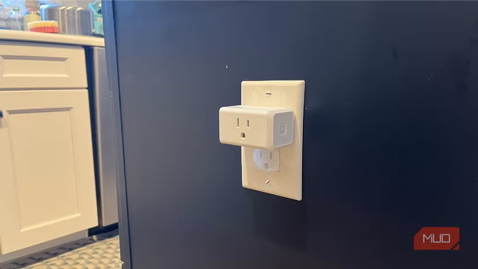 A Kasa smart plug inserted into an island outlet