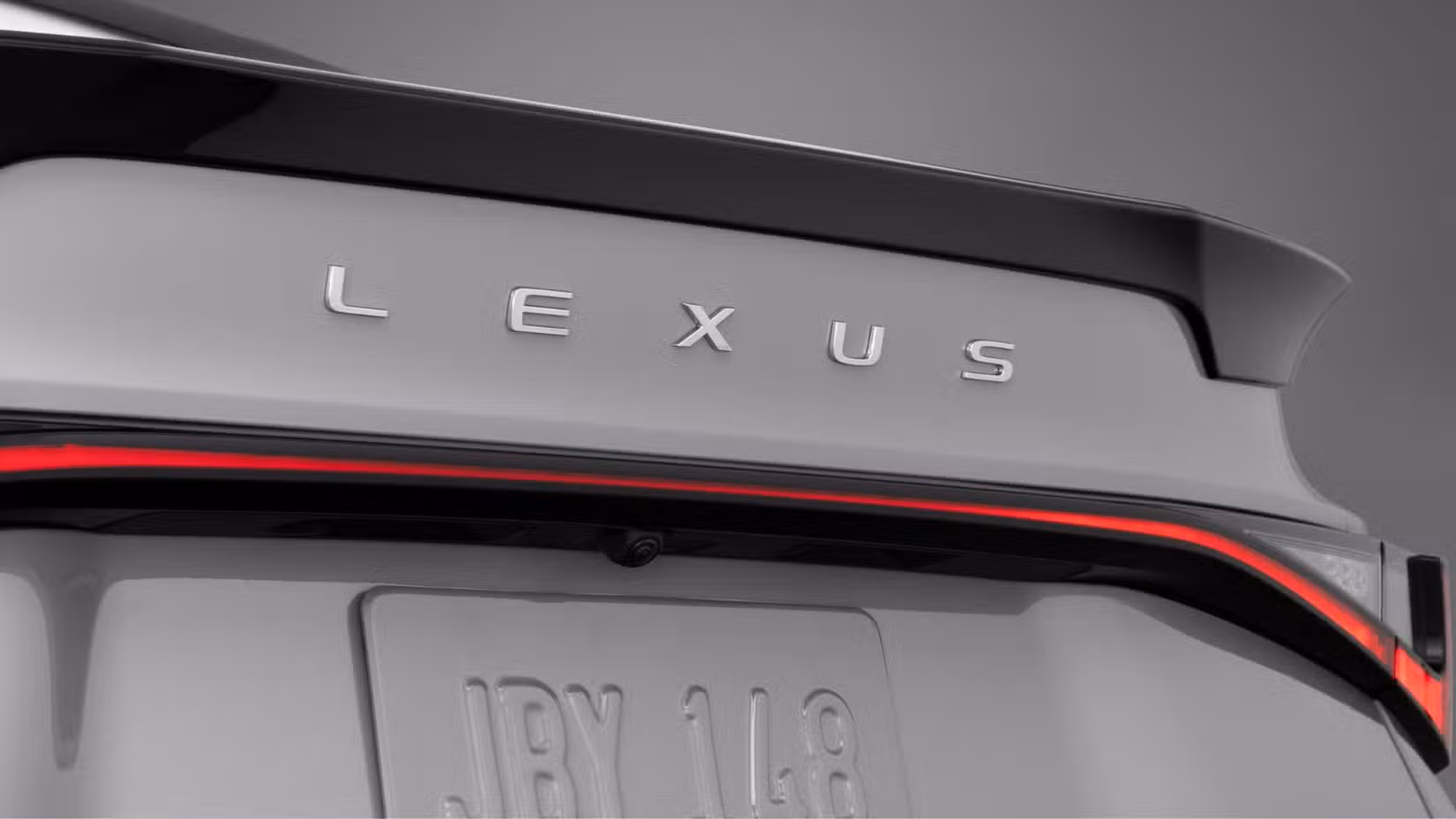 Close-up shot of the trunk lid badging on a gray 2026 Lexus IS 350.