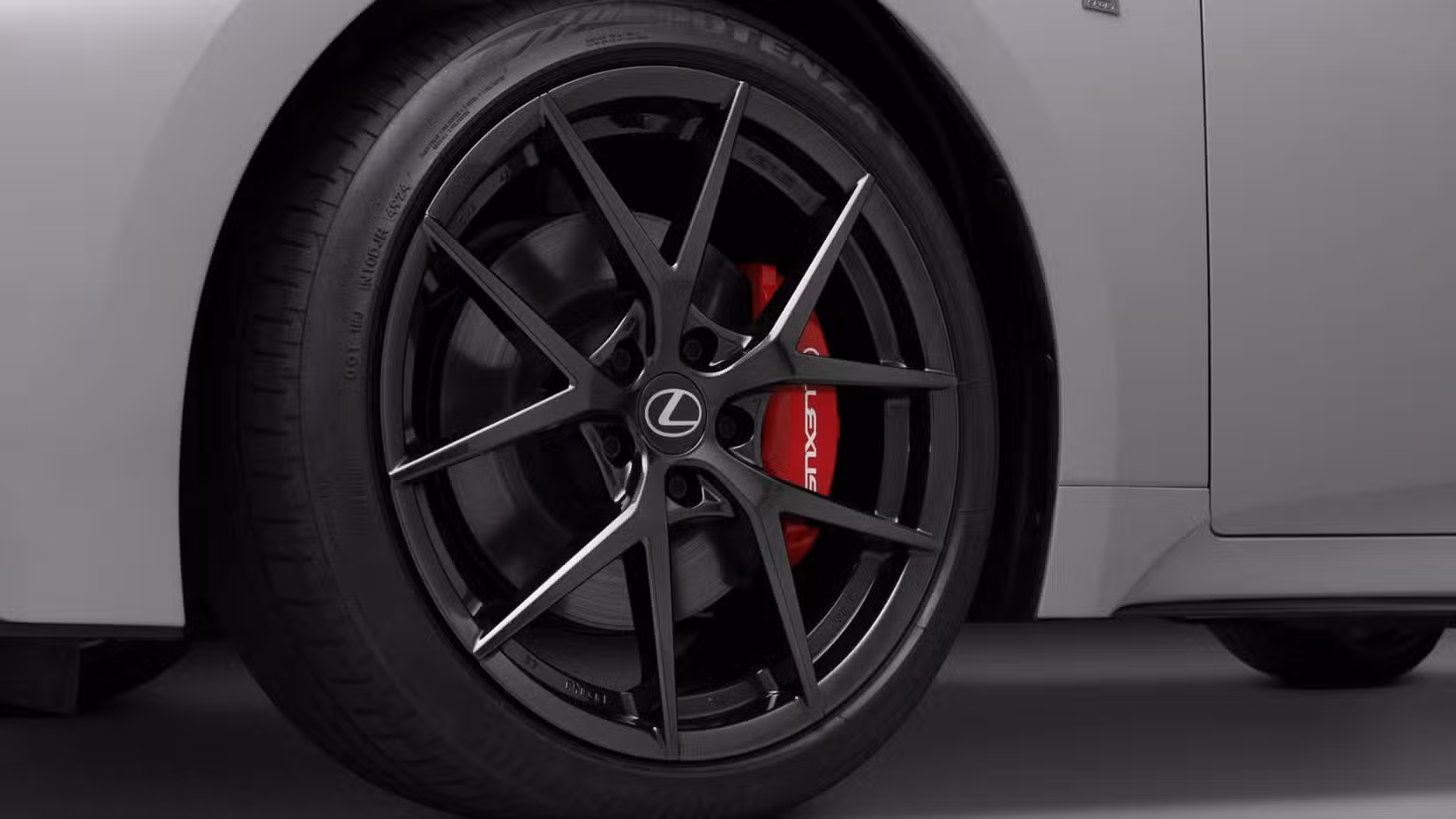 Close-up shot of the alloy wheel on a gray 2026 Lexus IS 350.