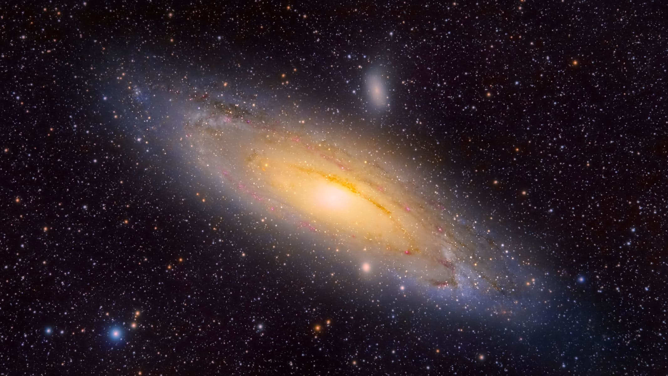 A deep-space photograph of the Andromeda Galaxy (M31) surrounded by stars.