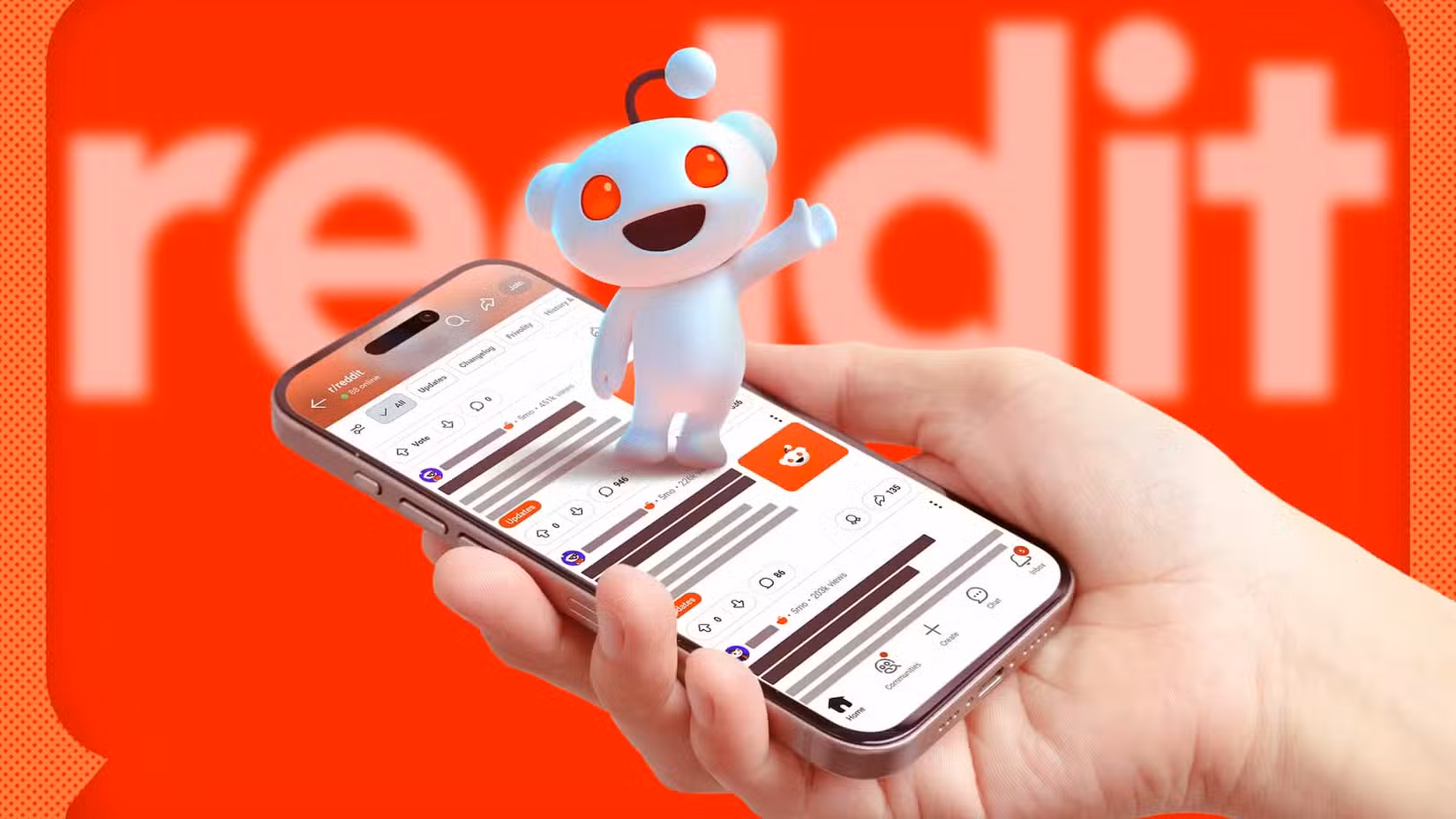 A hand holding a phone with Reddit open, the Reddit mascot on the screen, and the logo blurred in the background.