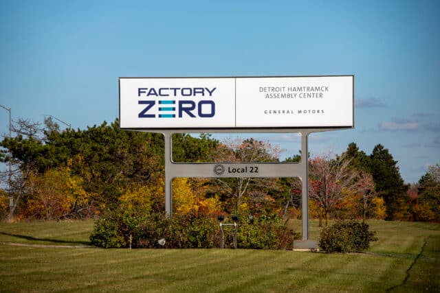 DETROIT, MICHIGAN - OCTOBER 29: A sign for General Motors' Factory Zero plant is seen on October 29, 2025 in Detroit, Michigan. General Motors announced today it will be laying off 3,300 hourly employees around the country at plants that make electric vehicles and batteries due to slowing EV consumer interest. GM's all-electric Factory Zero plant, which manufactures the Chevrolet Silverado EV and the GMC Sierra EV, among others, will be hit the hardest, with 1,200 workers to be laid off. (Photo by Bill Pugliano/Getty Images)