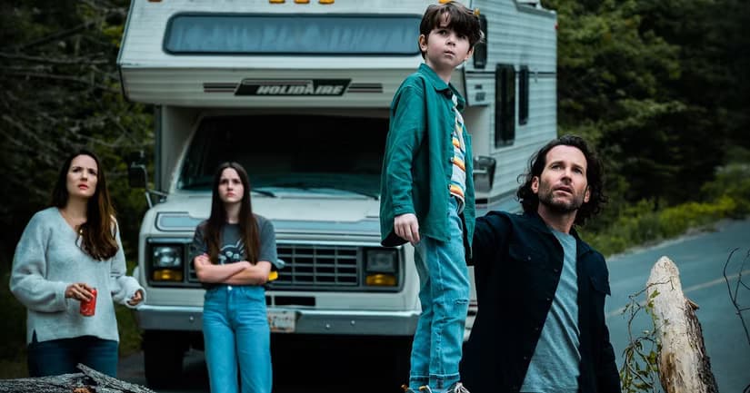 The Matthews family stand in front of their RV looking at the sky in From.