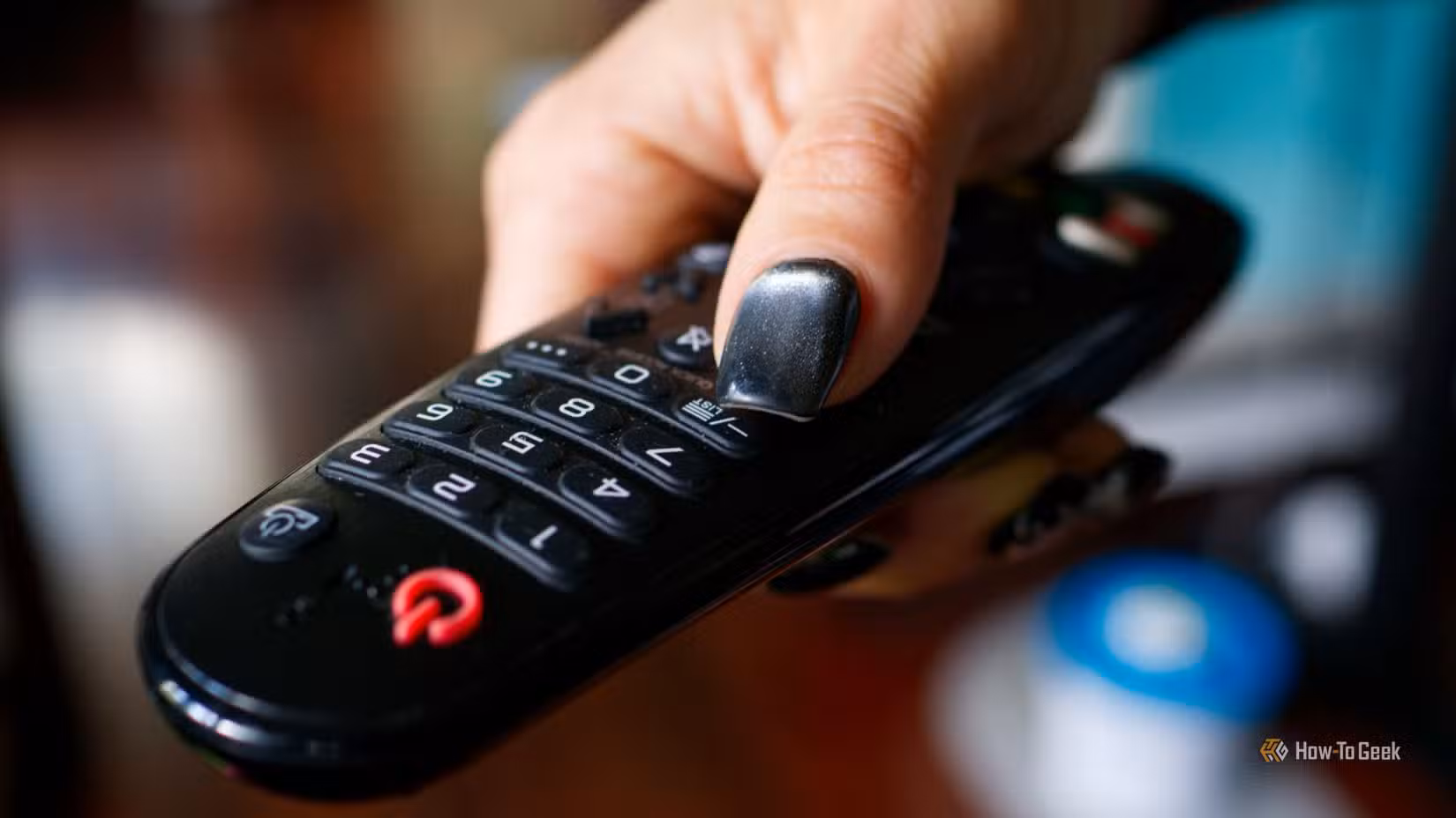 A person holding an infrared TV remote.