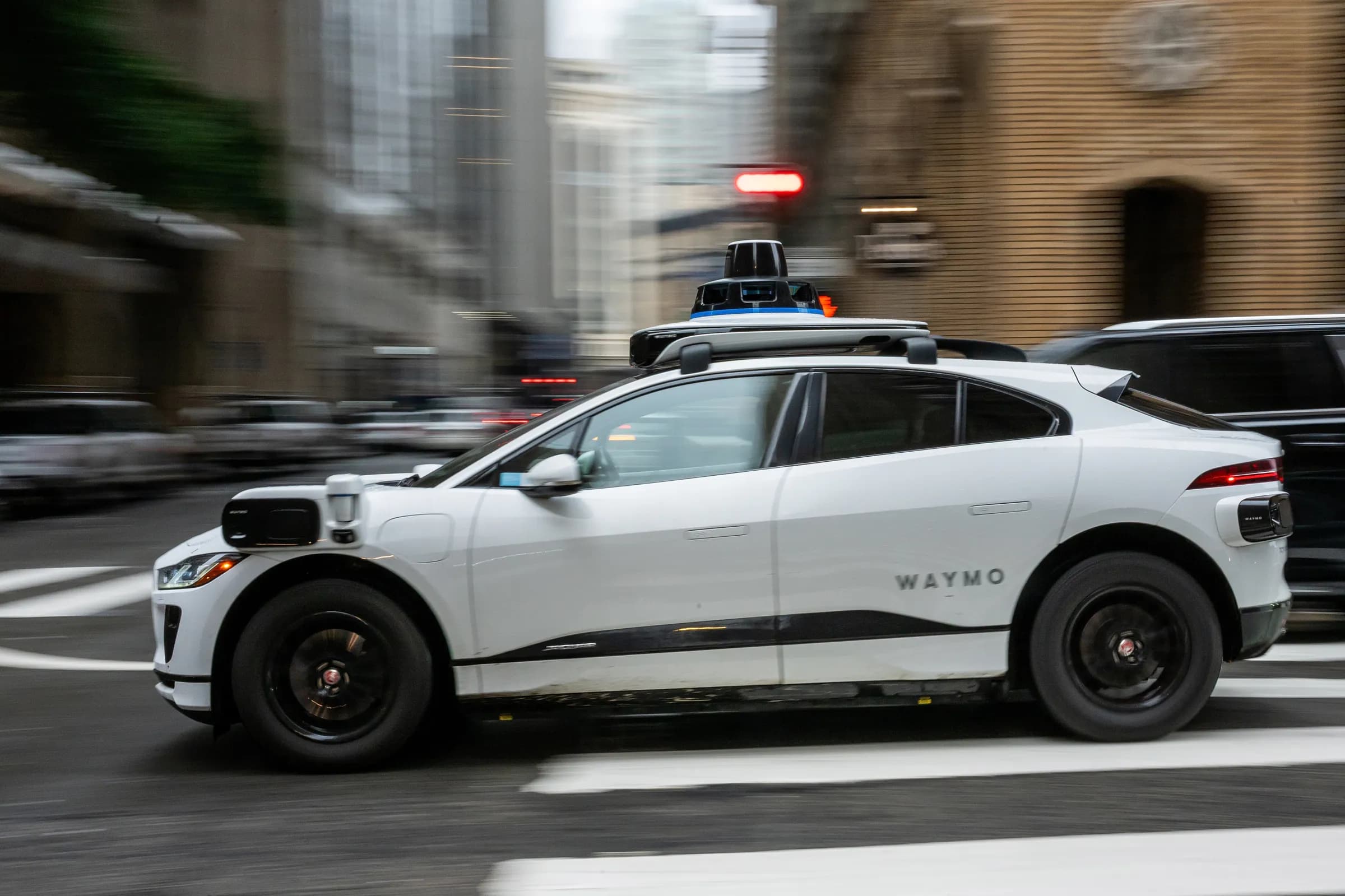 A Waymo autonomous taxi on Bush Street in San Francisco, California, US, on Wednesday, Dec. 17, 2025. Waymo, Alphabet Inc.‘s autonomous driving unit, is in discussions to raise more than $15 billion at a valuation near $100 billion, in a financing round led by its parent company. Photographer: David Paul Morris/Bloomberg via Getty Images