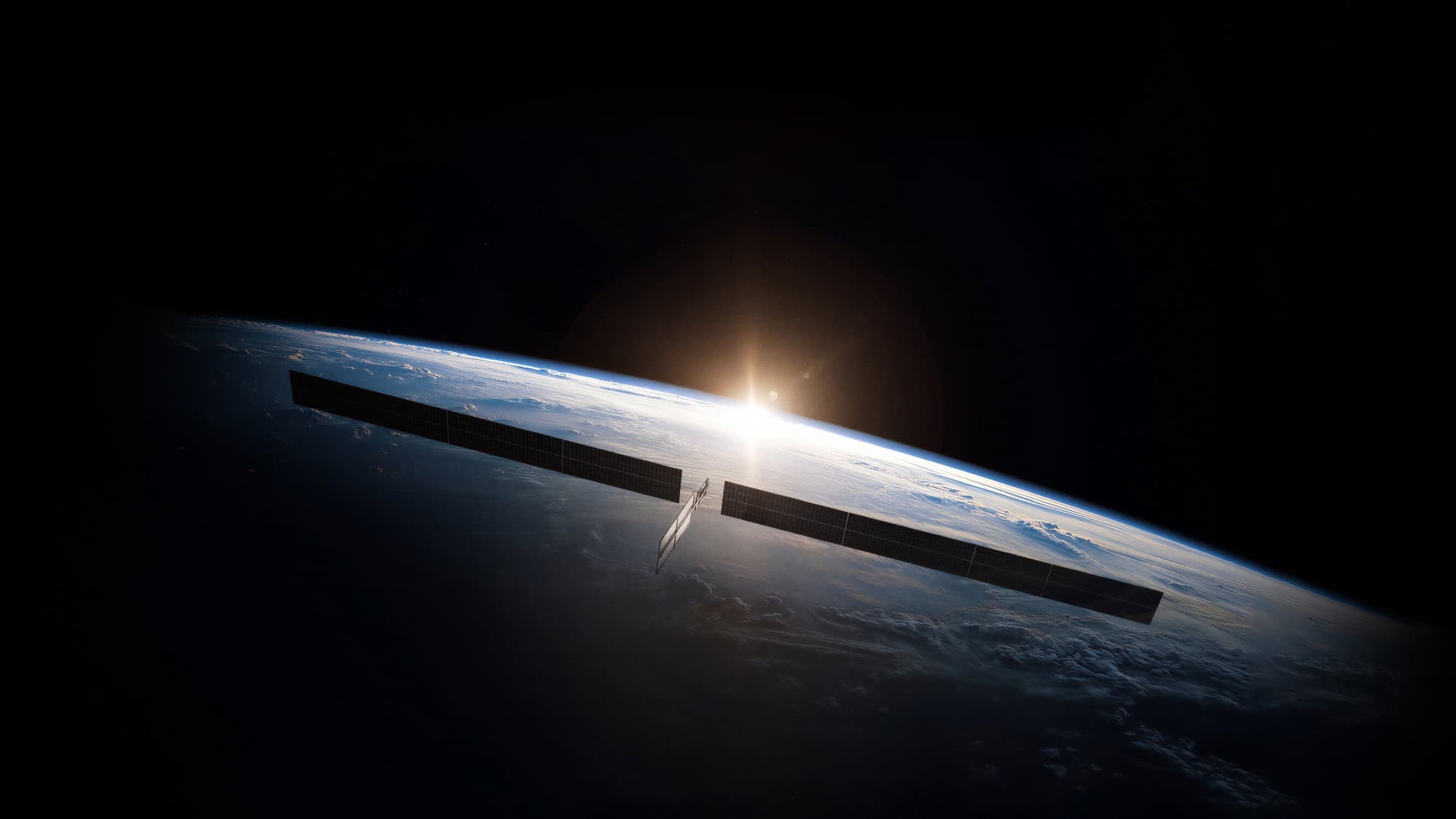 a small rectangular satellite with two very elongated wing-like solar arrays floats as the sun rises in the distance above the curvature of earth