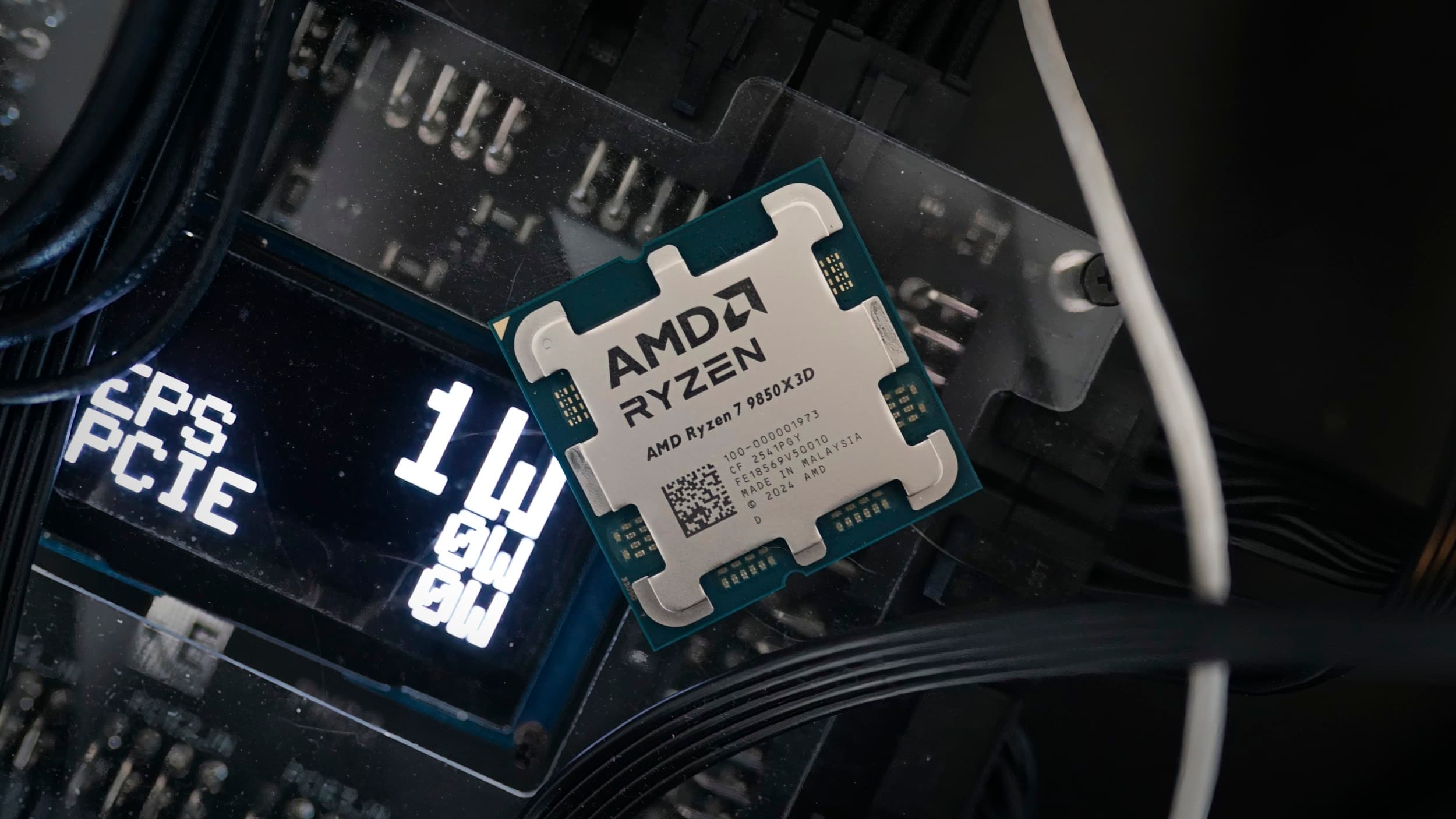 The AMD Ryzen 7 9850X3D CPU sitting on the PMD2 power tester.