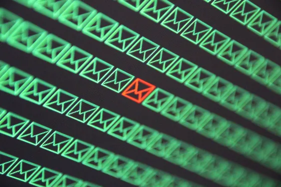 red email envelope in a sea of green email envelopes