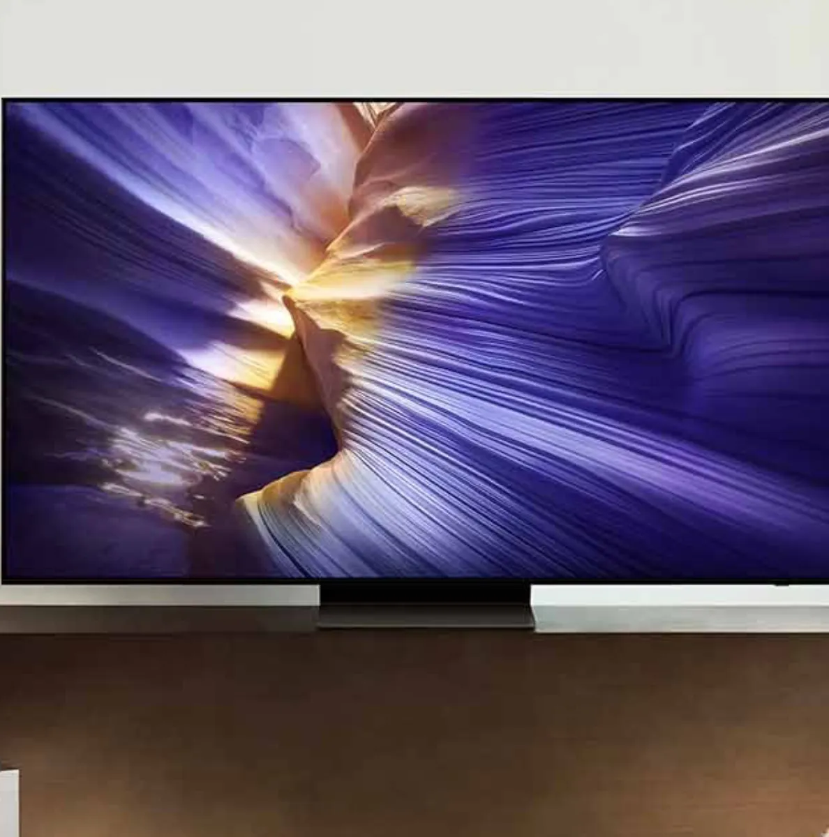 Samsung's S90F 4K TV on top of a stand.