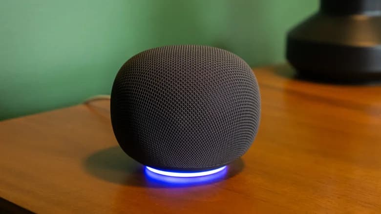 The Google Home smart speaker with its light ring activated.