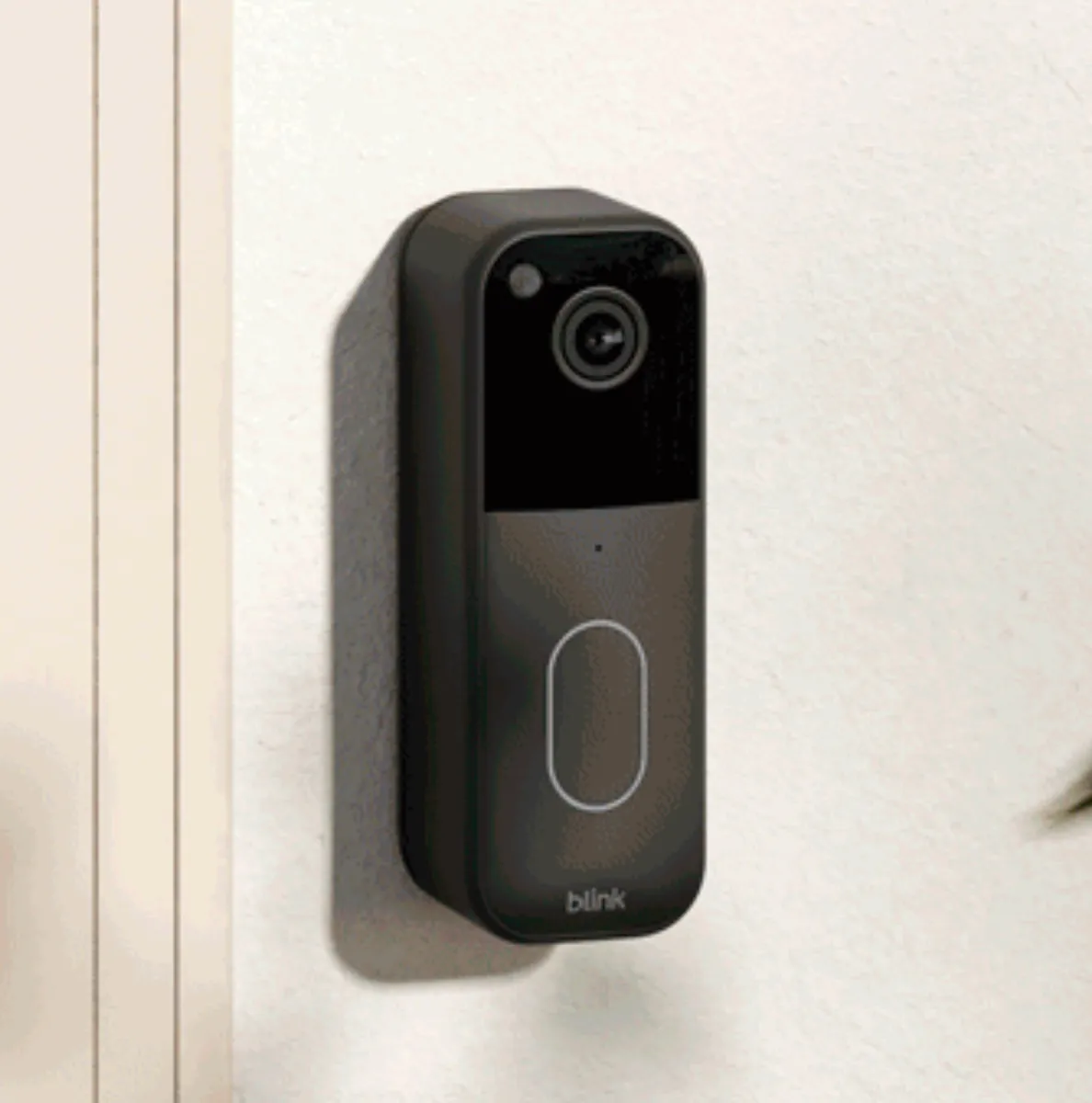 Blink’s second-generation Video Doorbell next to a door.