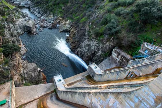 a photo of a dam in Spain seen spilling water.