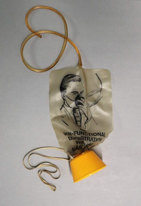 Aircraft oxygen mask demonstration model used by flight crew, illustrating the 'put on your own mask first' concept for managing intrusive AI
